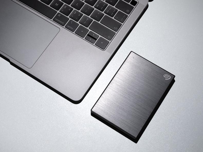 External hard drive next to a laptop