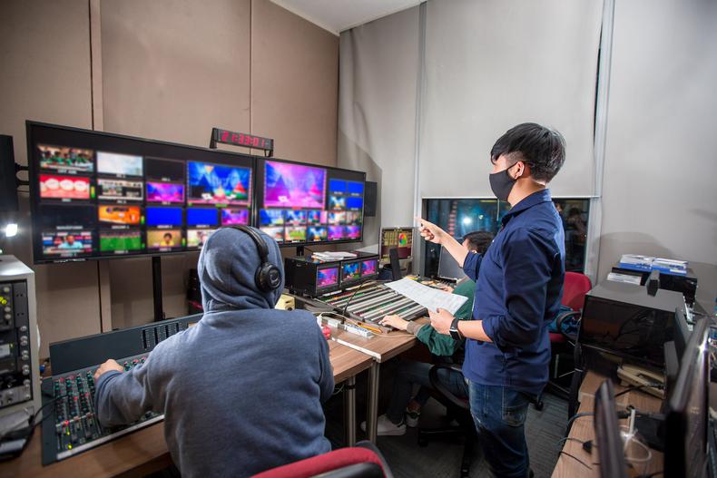 Film producer working in front of monitors