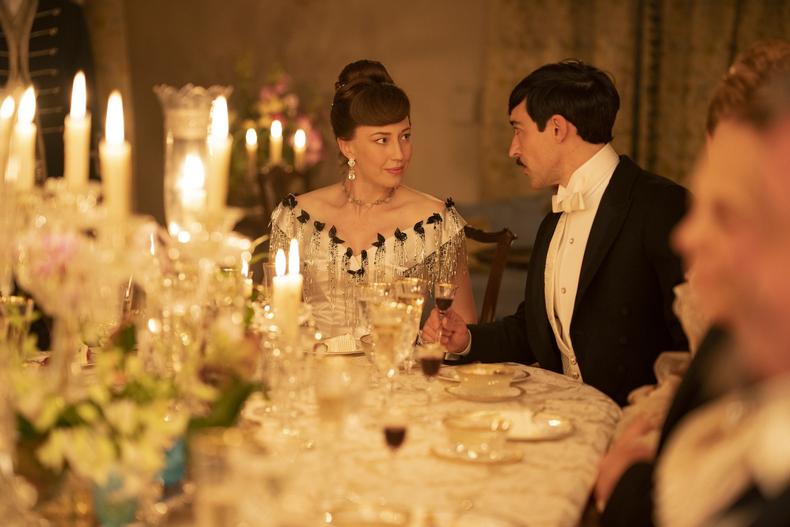 Man and woman in a fine-dining setting on 'The Gilded Age'