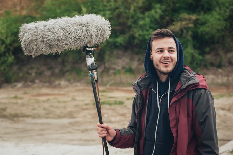 Crew member holding a boom mic