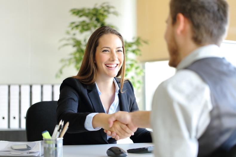 Man and woman shaking hands in an office