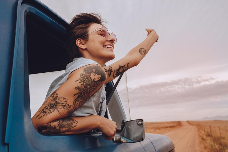 Tattooed woman in a truck window