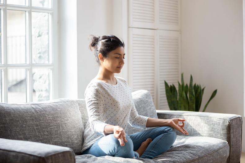 Woman meditating on a couch