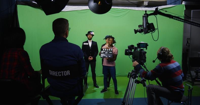 Actors in front of a green screen
