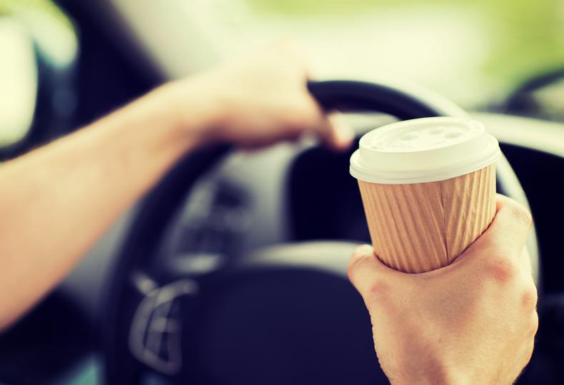 Holding a coffee cup while driving