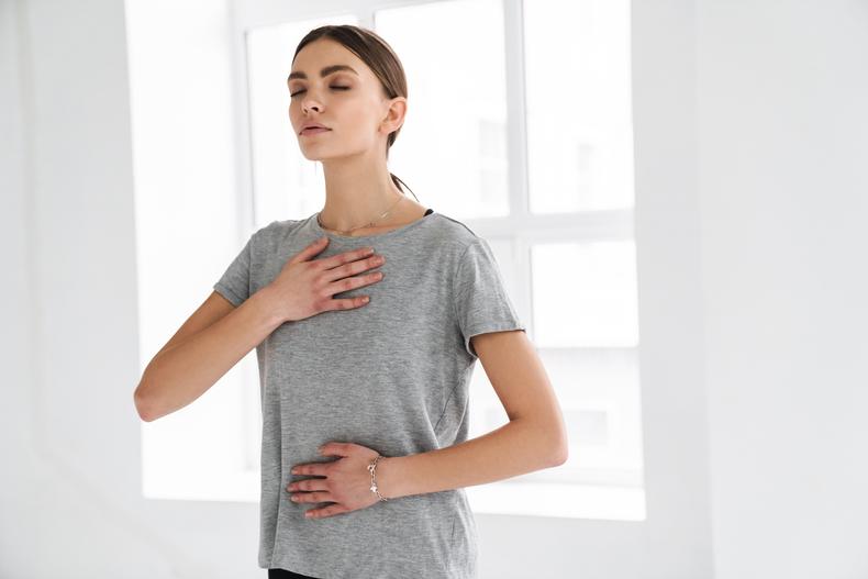 Woman performing a breath control exercise