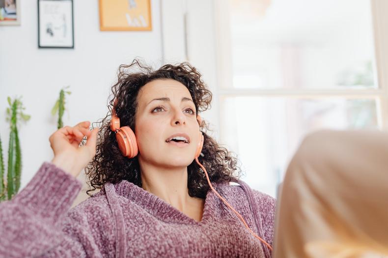 Woman wearing headphones performing vocal slides