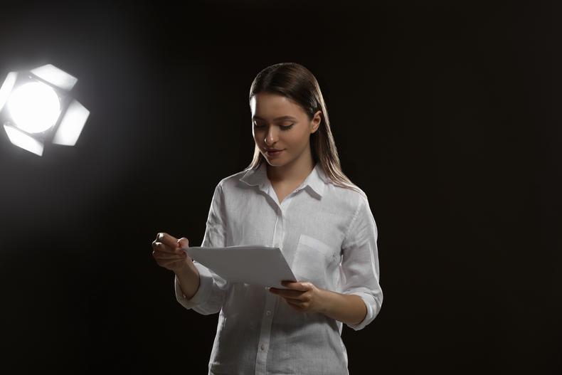 Actor reading a script on stage