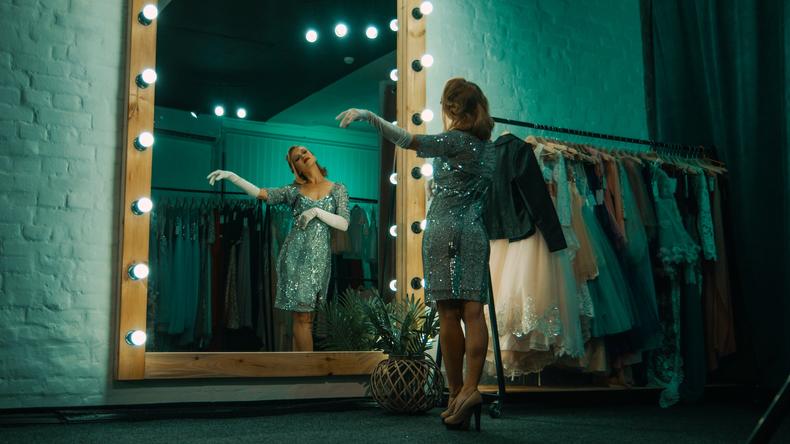 Woman posing in front of a mirror