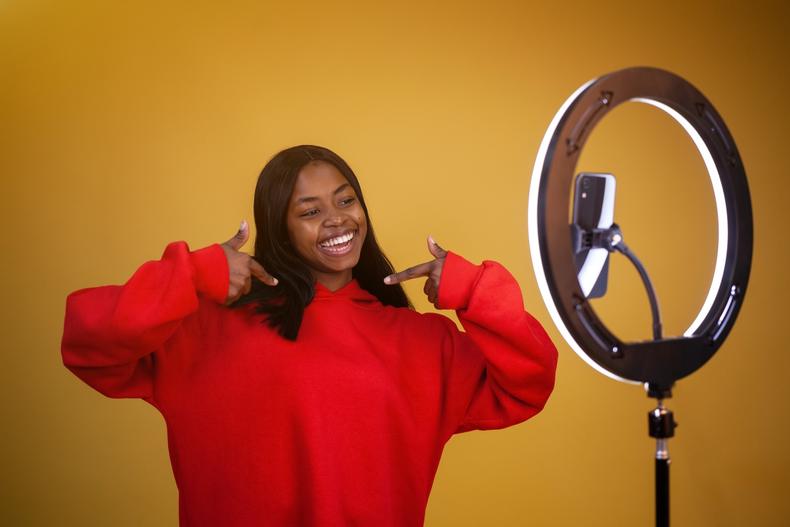 Woman posing in front of a ring light