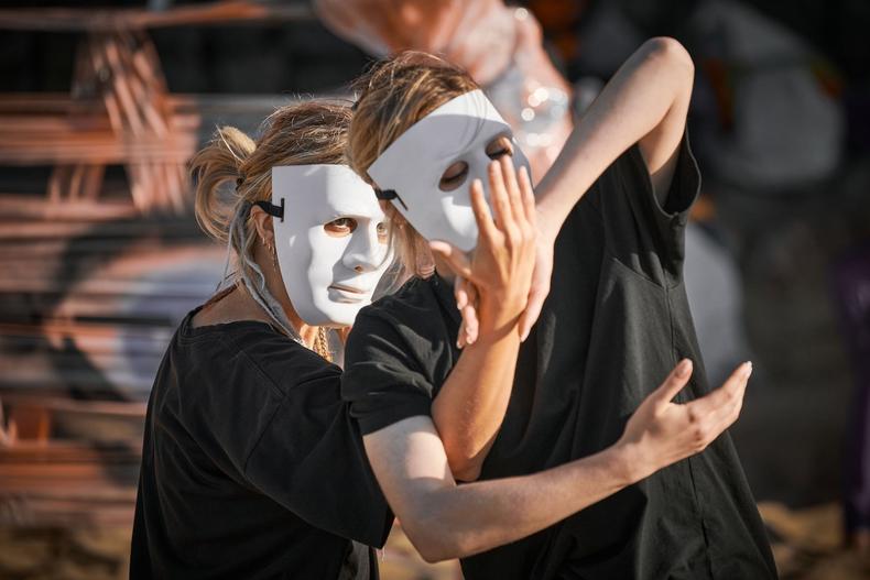 Actors performing while wearing masks