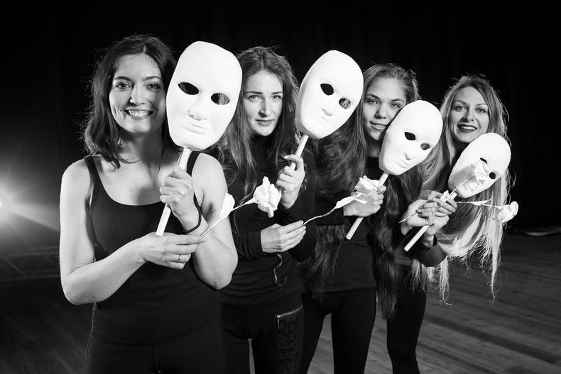 Teen actors holding prop masks