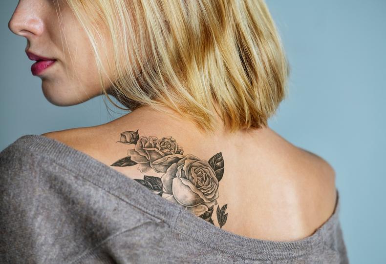 Model showing off back tattoo