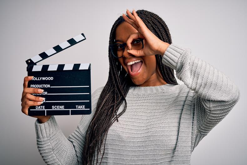 Woman holding a clapperboard