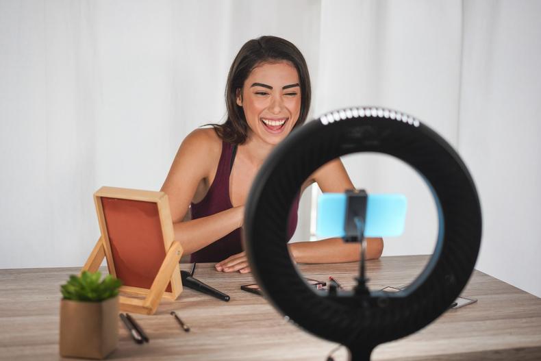 Woman using a ring light while recording a video