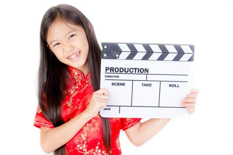 Female child holding a clapperboard