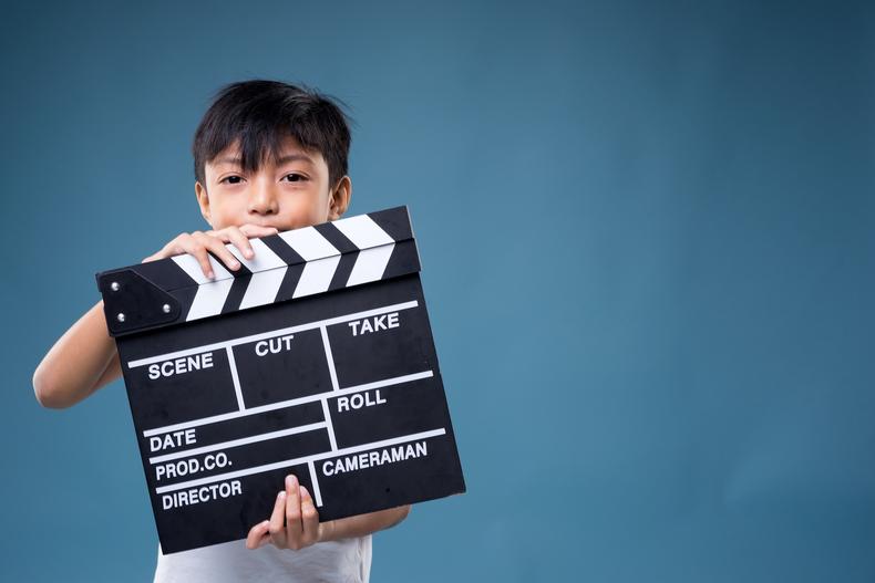 Child actor holding a clapperboard