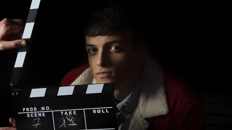 Actor behind clapboard