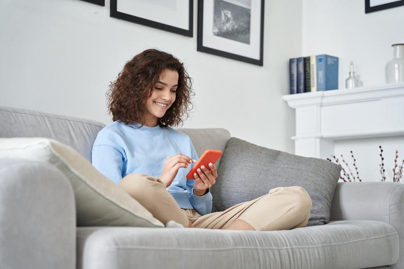 Woman using phone on couch