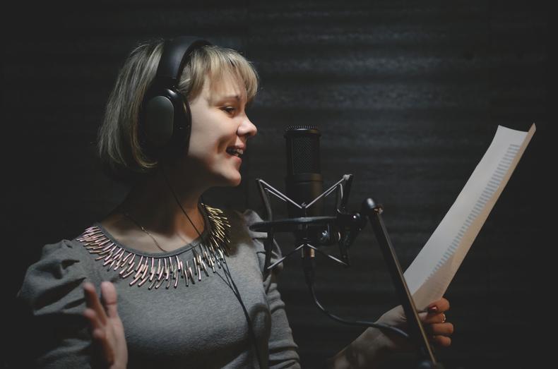 Woman singing in recording studio