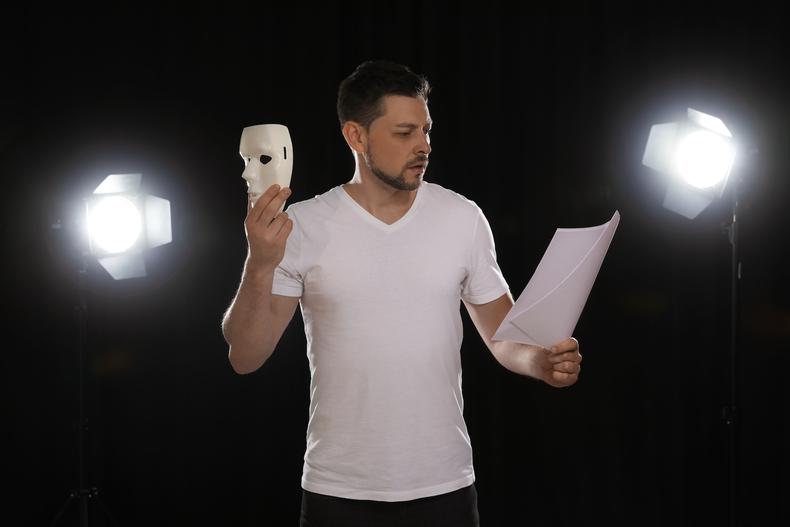 Actor holding mask
