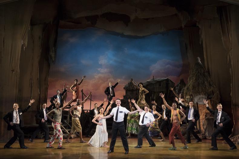 Dave Thomas Brown as Elder Price, center, and company, in The Book of Mormon