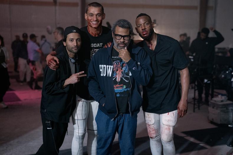 L to R: Director Justin Tipping, Tyriq Withers, Producer Jordan Peele, and Marlon Wayans on the set of “Him” Credit: Parrish Lewis/Universal Pictures